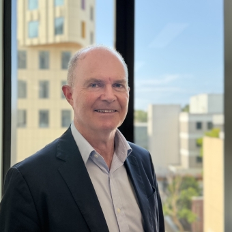 Tim Regan standing smiling for a photo