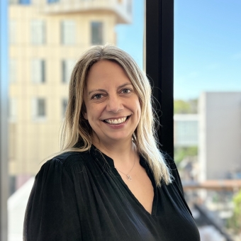 Zoe Kumar standing smiling at RHIP