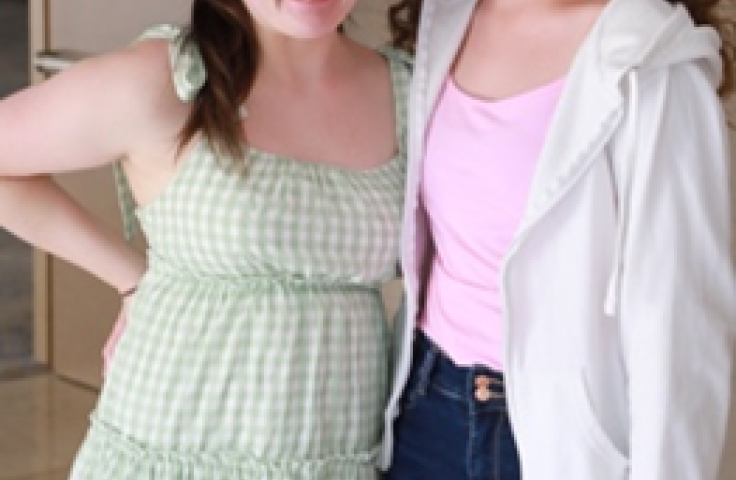  Photograph by Rick Guidotti featuring two young women, smiling, and looking at the camera. These woman live with rare disease. 